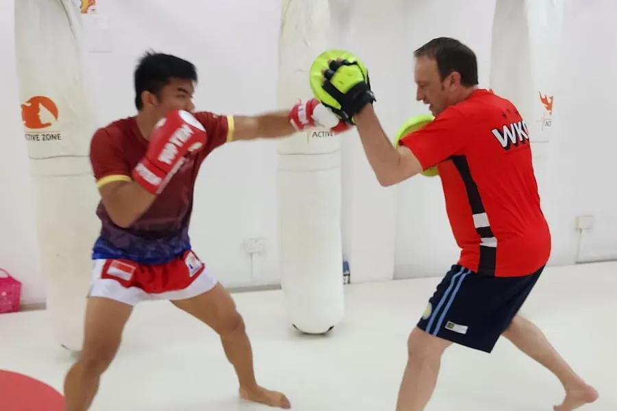 Pad work in the adult kickboxing class at WKO Llanelli